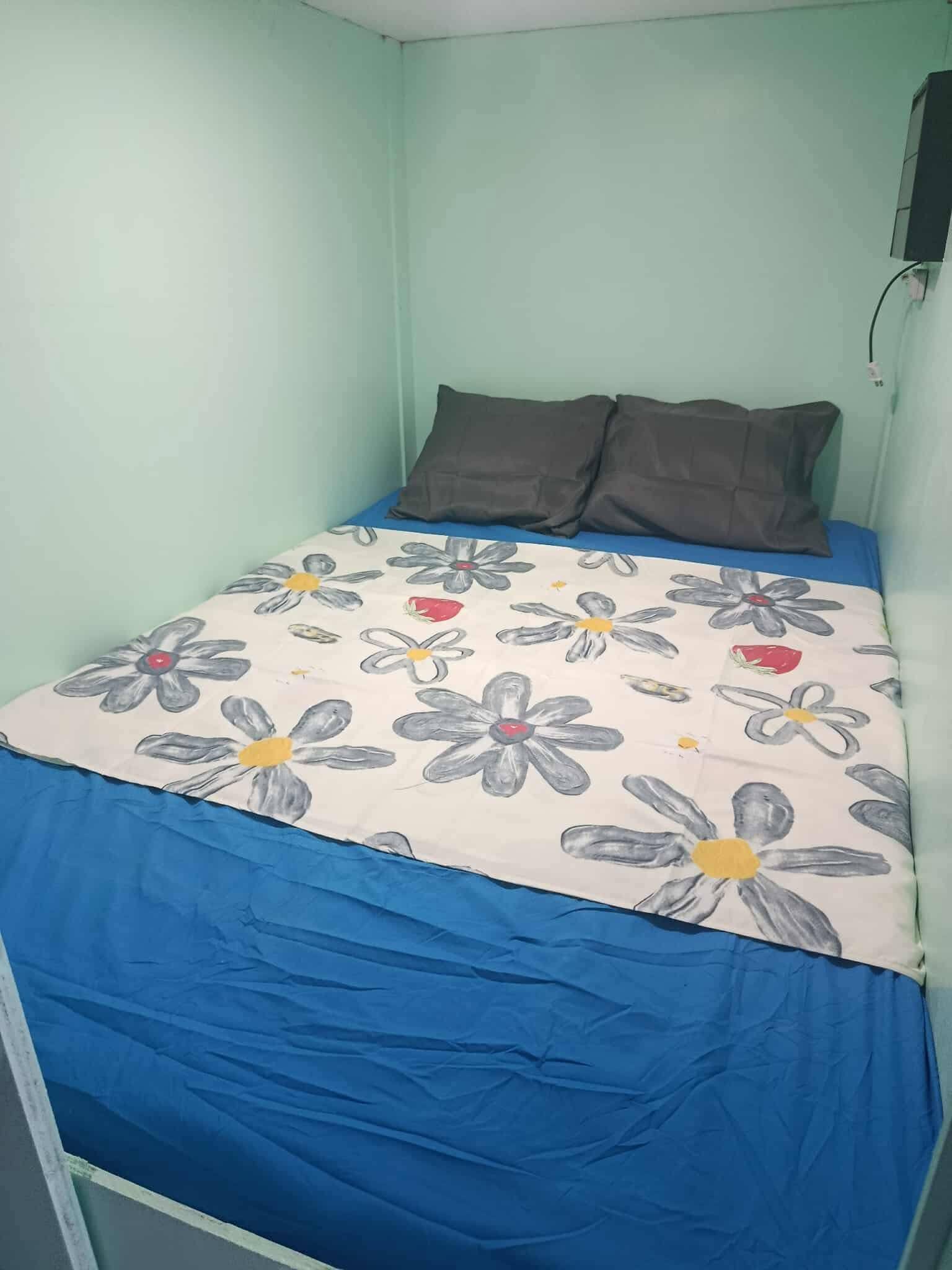 Capsule room with comfortable blue bedding at UniCapsules Pasay City