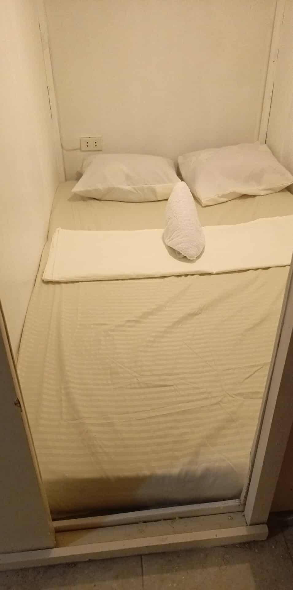 Clean white capsule room with fresh towel at UniCapsules